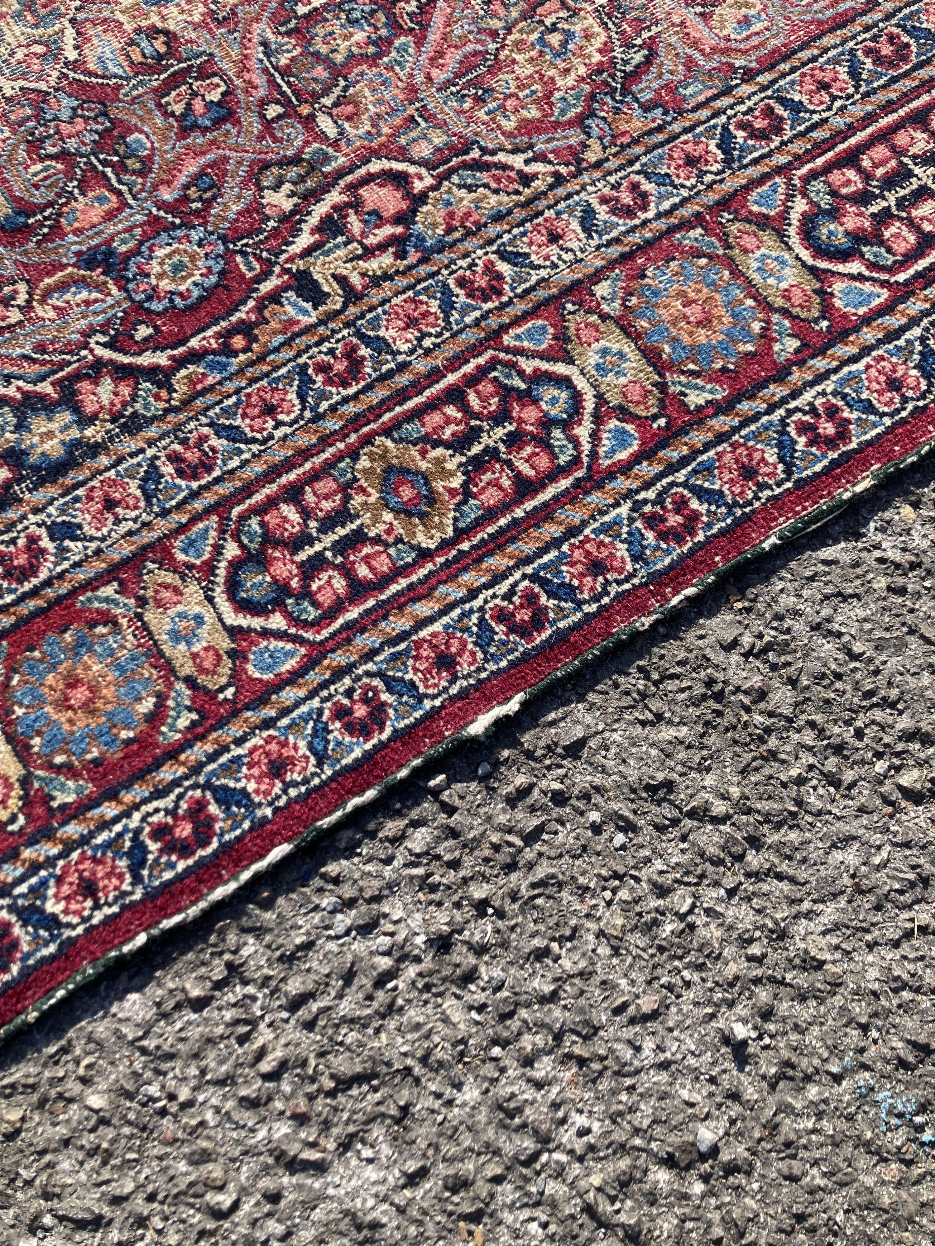 A North West Persian red ground rug (worn), 127 x 76cm